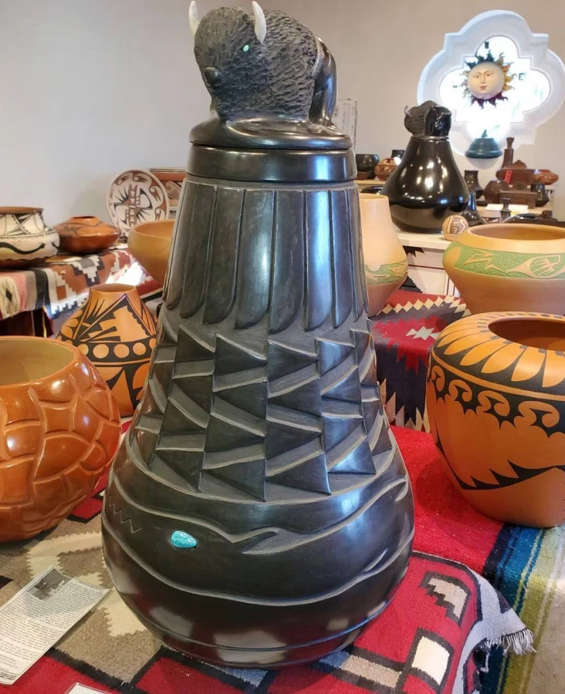 Black pottery vase with buffalo design
