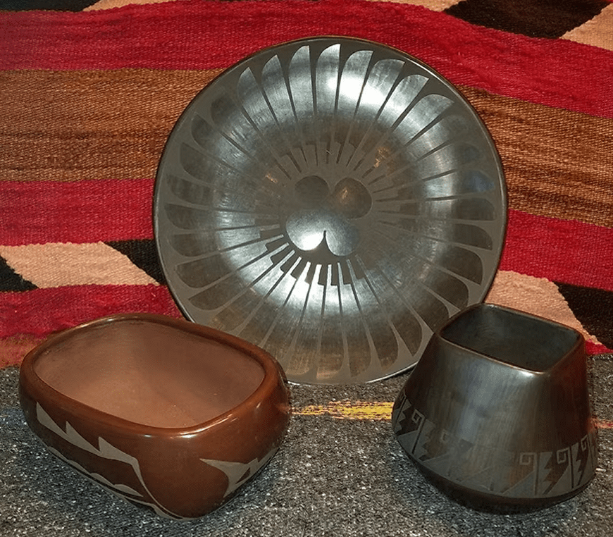Three handcrafted ceramic pots and plate