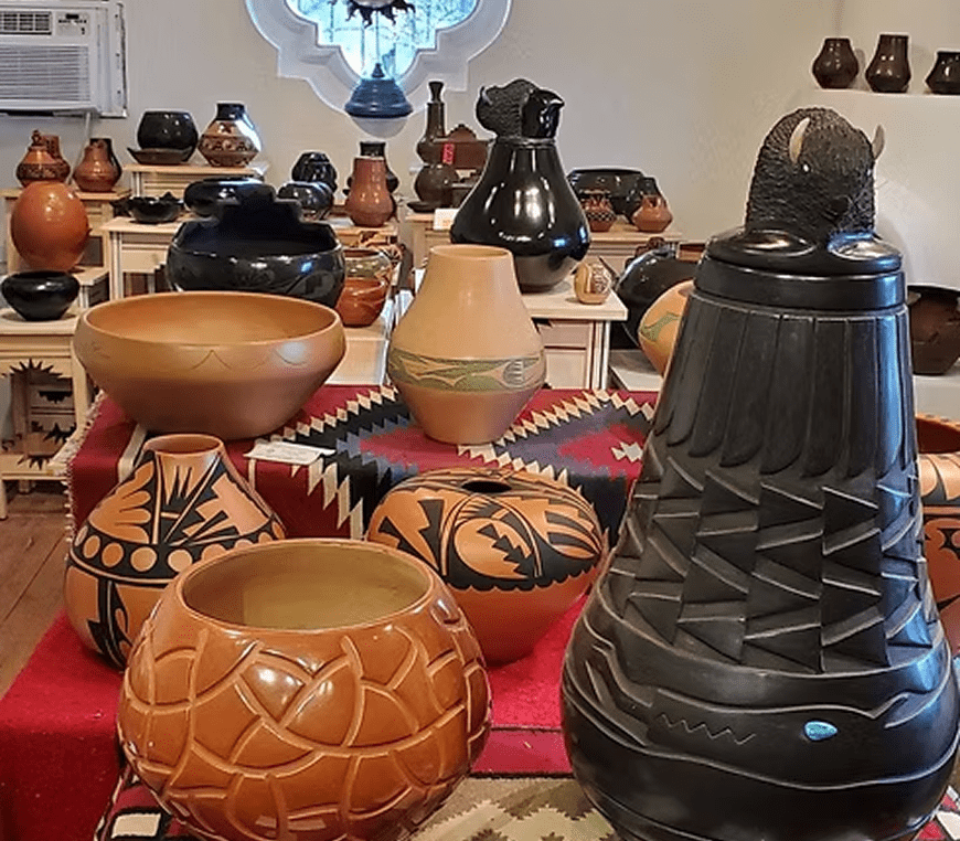 Assorted clay pots on colorful textiles