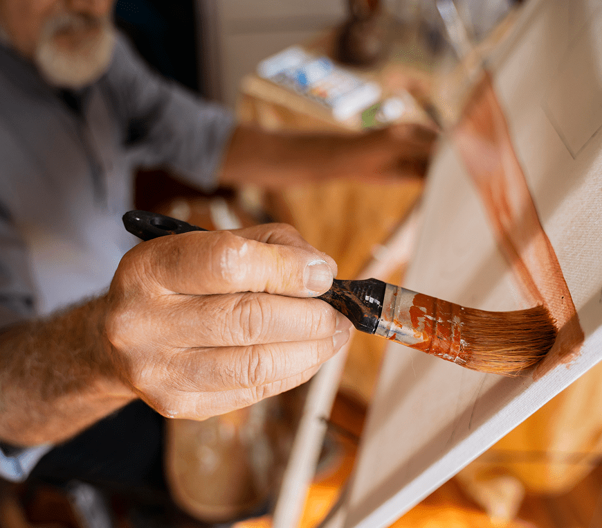 Person creating art with paintbrush